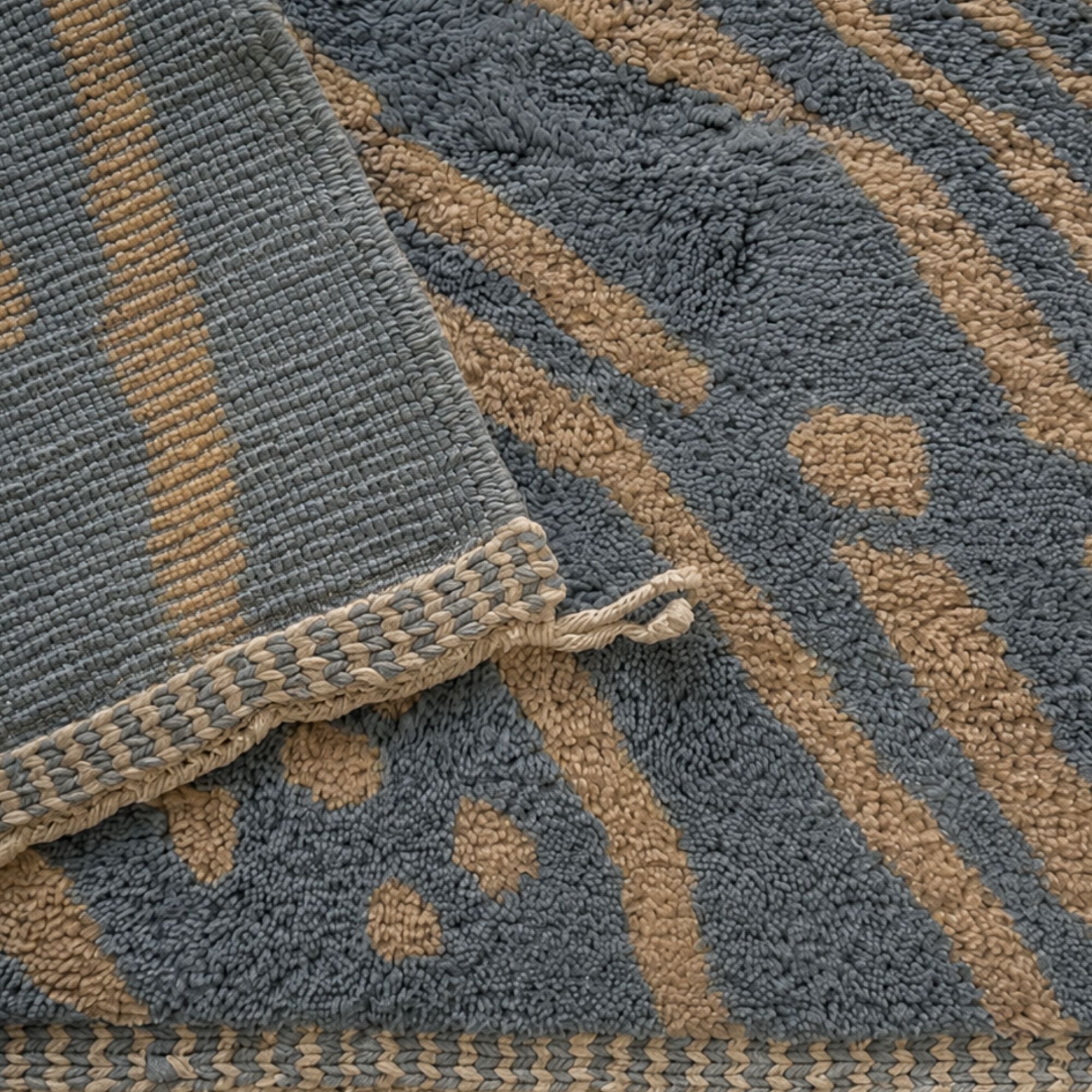 Handwoven Moroccan wool rug detail showing the blue-grey and camel pattern and artisan-finished edge