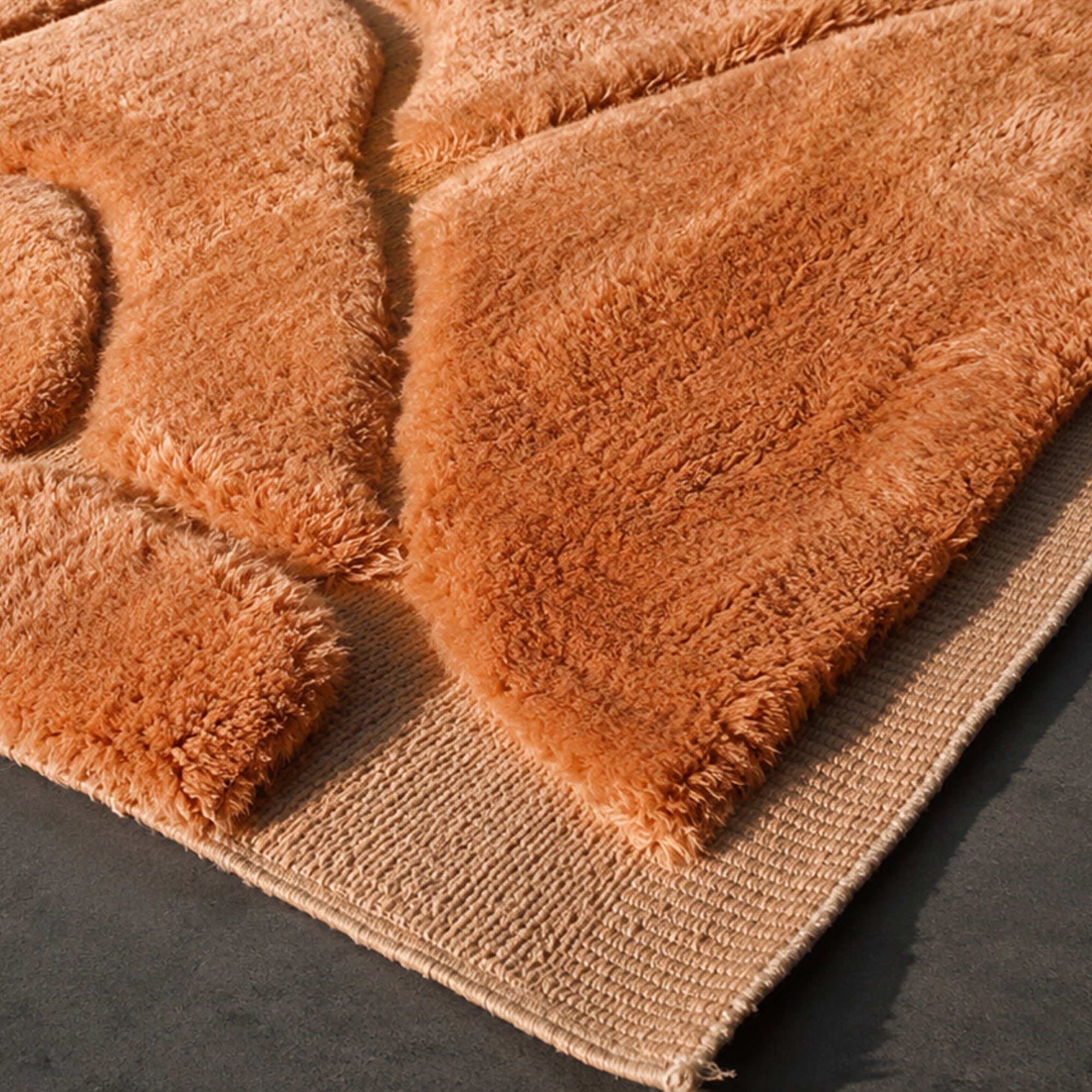 Handwoven Moroccan wool rug, Contour No. 02 design, close-up of high-pile burnt-orange wool with carved lines.