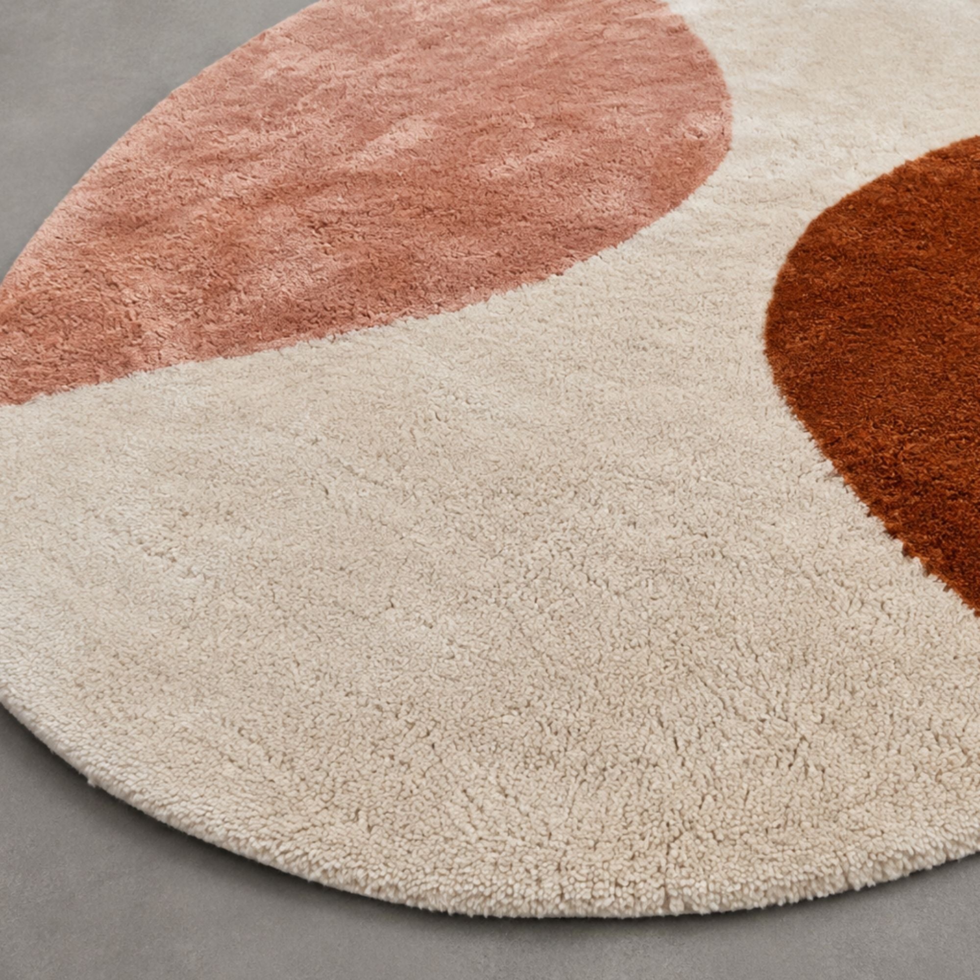 Handwoven Moroccan wool rug, Cove design, close-up of rust and dusty rose shape edges on ivory pile.