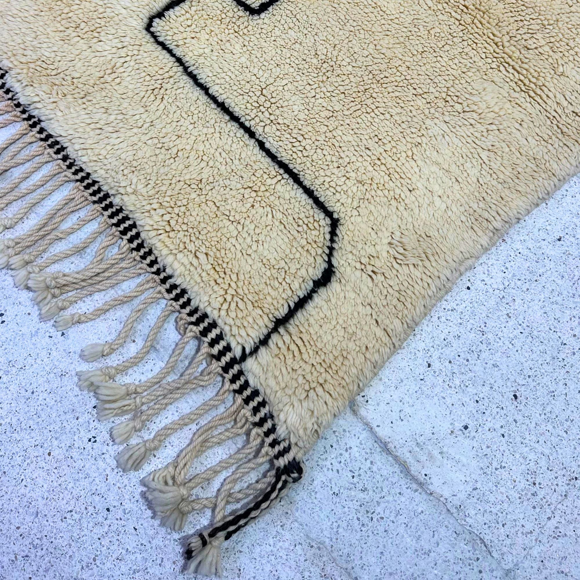 White shag Moroccan rug with a bold black contemporary design, handwoven by Berber artisans.