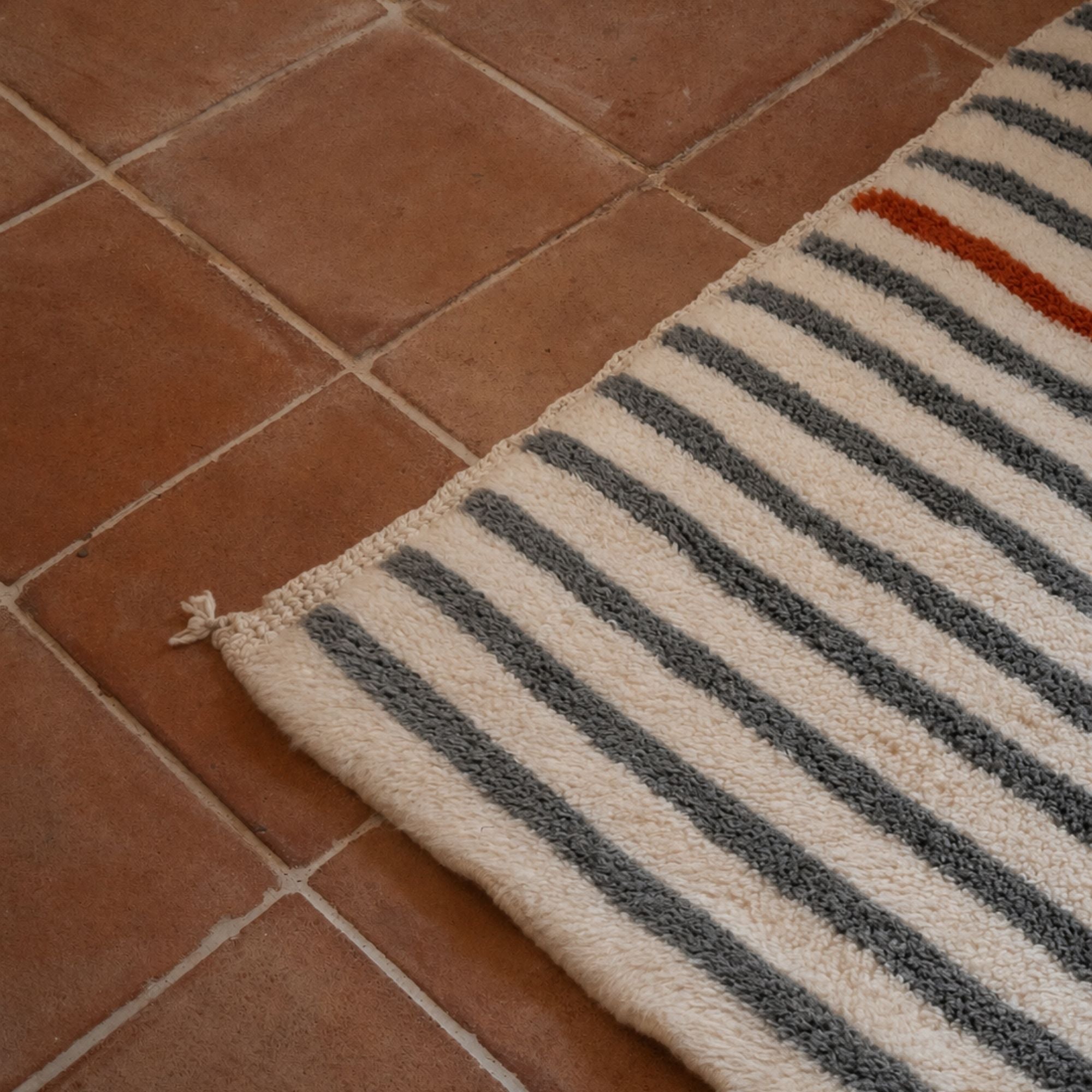 Ivory and grey striped Moroccan wool rug with terracotta accent line