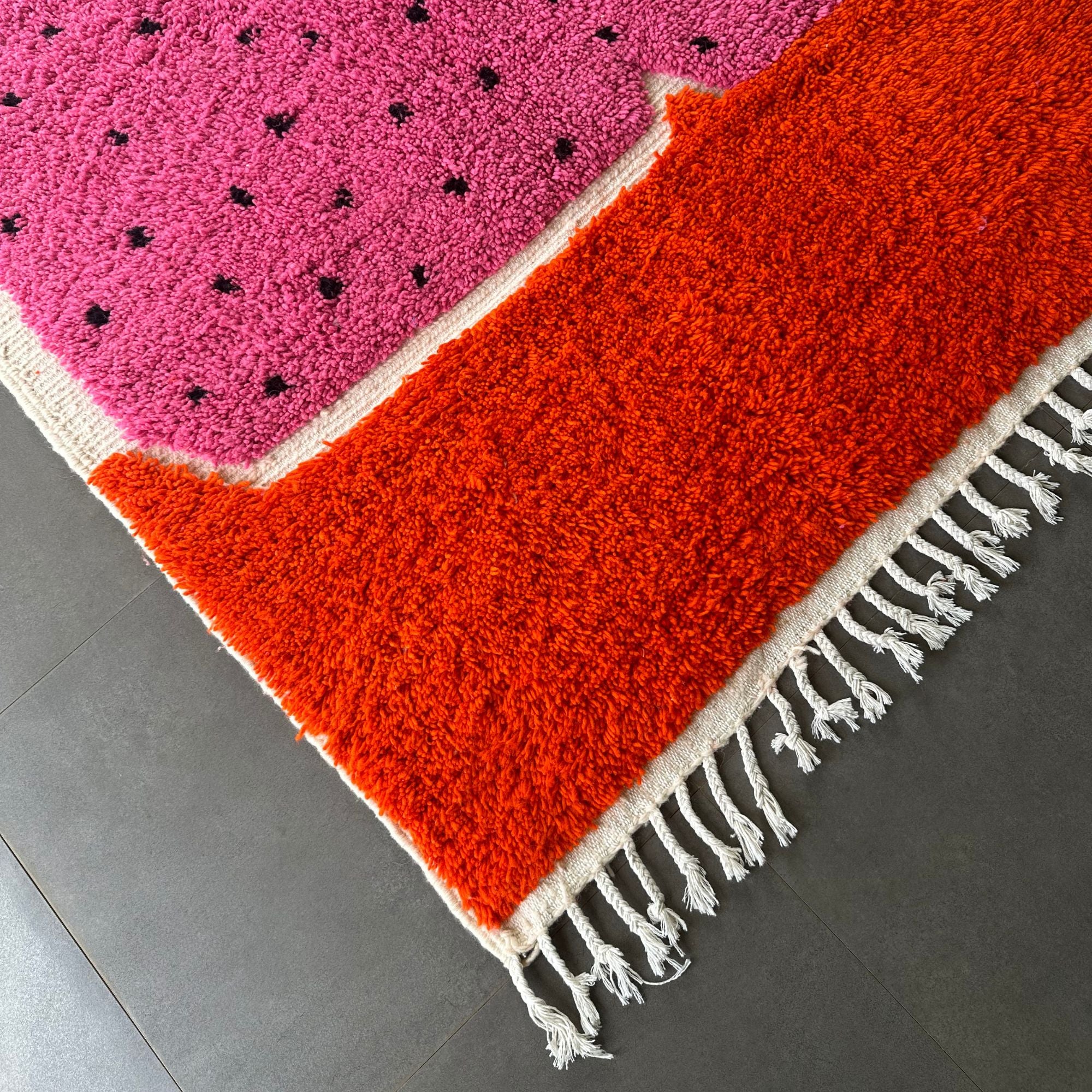 Melon Mirage pink Moroccan rug with a dotted design in black, handwoven by Berber artisans