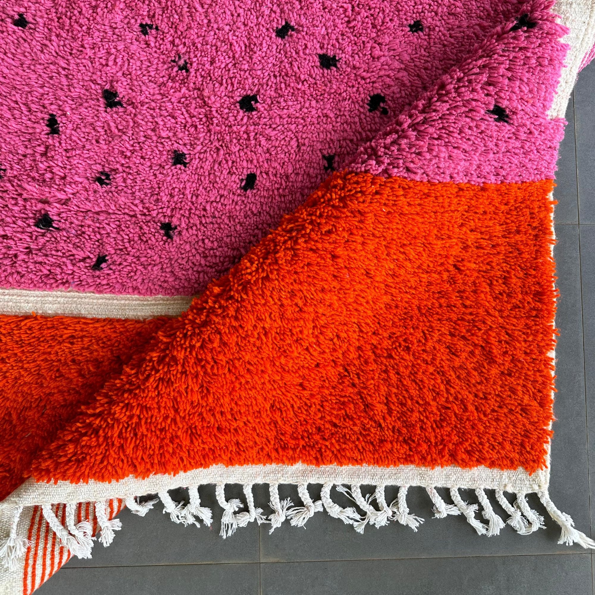 Melon Mirage pink Moroccan rug with a dotted design in black, handwoven by Berber artisans