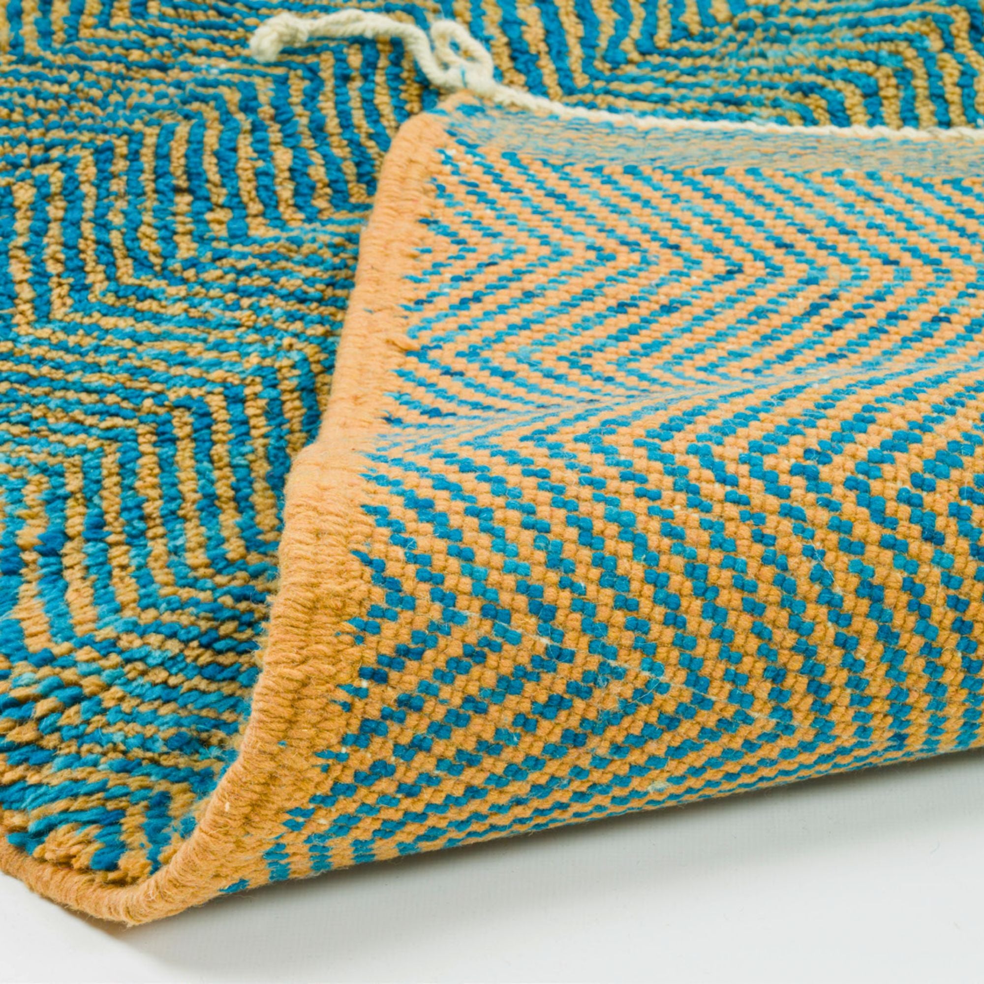 Moroccan Melody blue Moroccan rug with a zigzag design in blue and orange, handwoven by Berber artisans