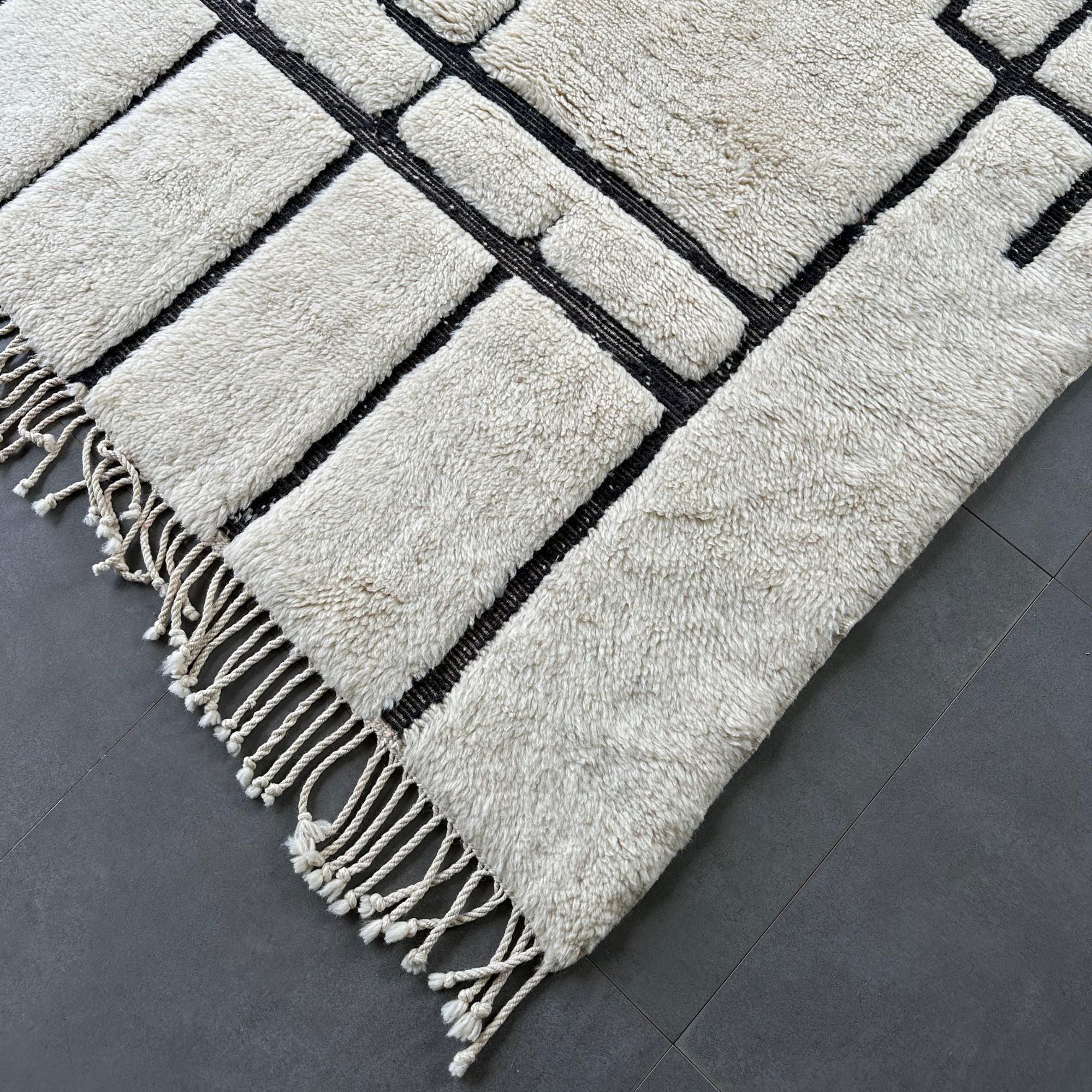 Mystic Muse white Moroccan rug with black geometric design, handwoven by Berber artisans.