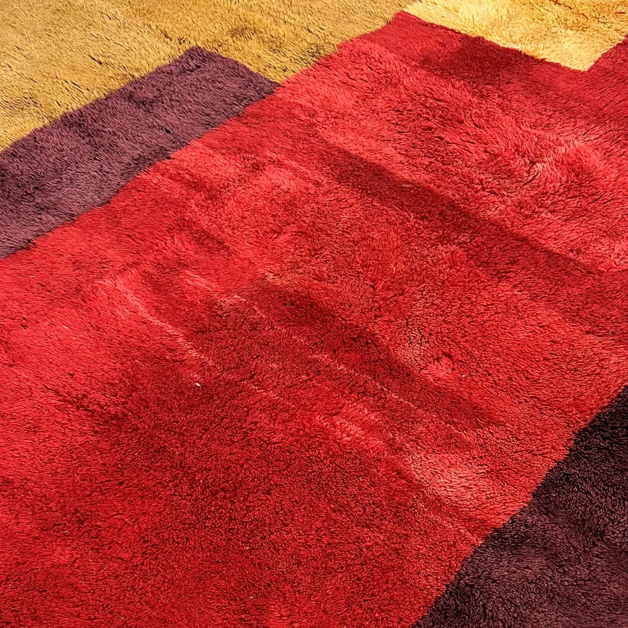  Mystical Marvel – A handcrafted Moroccan area rug featuring bold burgundy, red, and golden hues. A luxurious statement piece inspired by Moroccan landscapes.