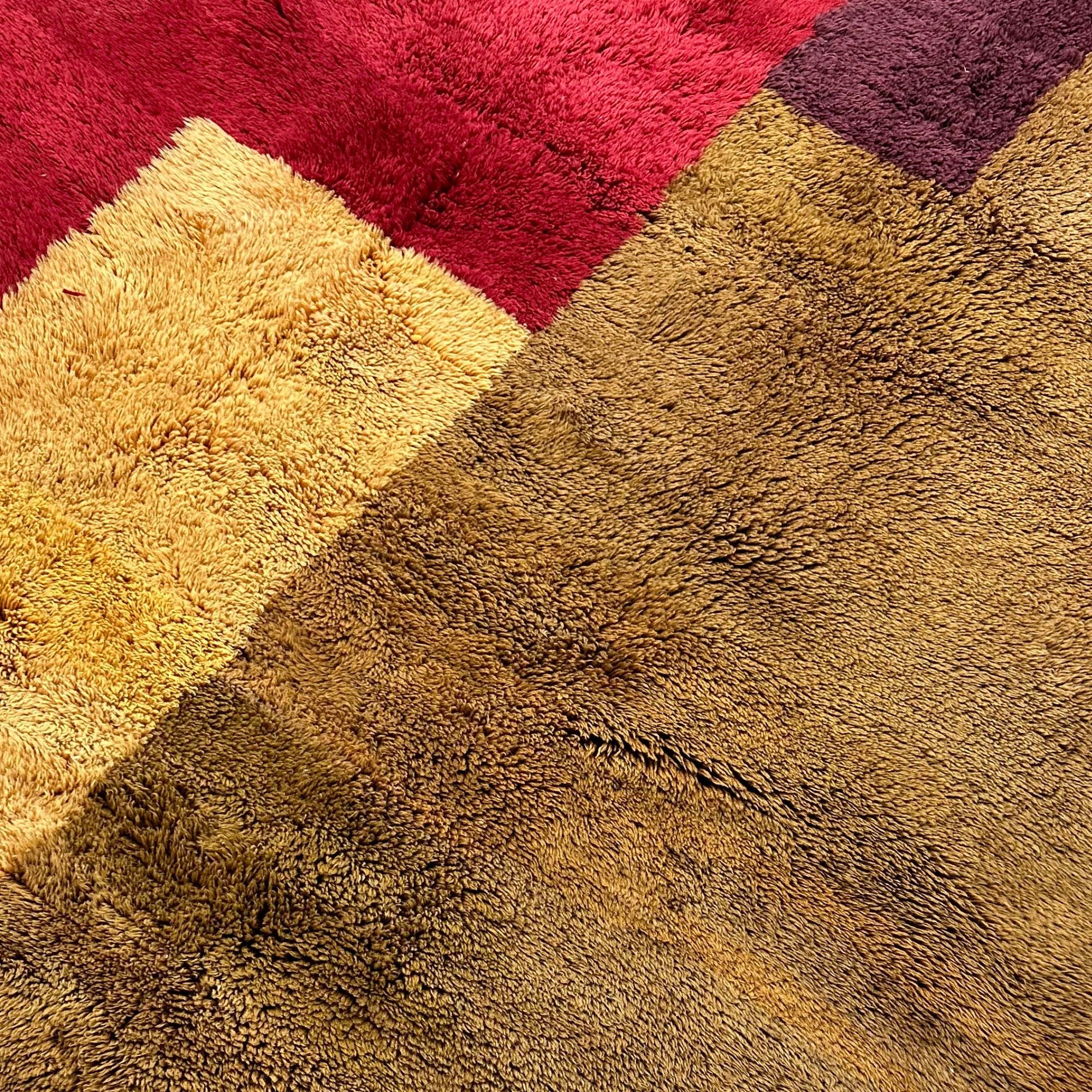  Mystical Marvel – A handcrafted Moroccan area rug featuring bold burgundy, red, and golden hues. A luxurious statement piece inspired by Moroccan landscapes.