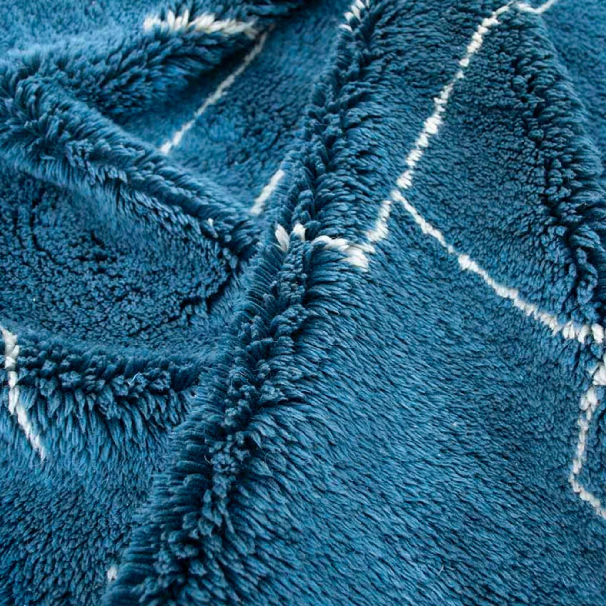 Oasis Elegance blue Moroccan rug with a white abstract design, handwoven by Berber artisans