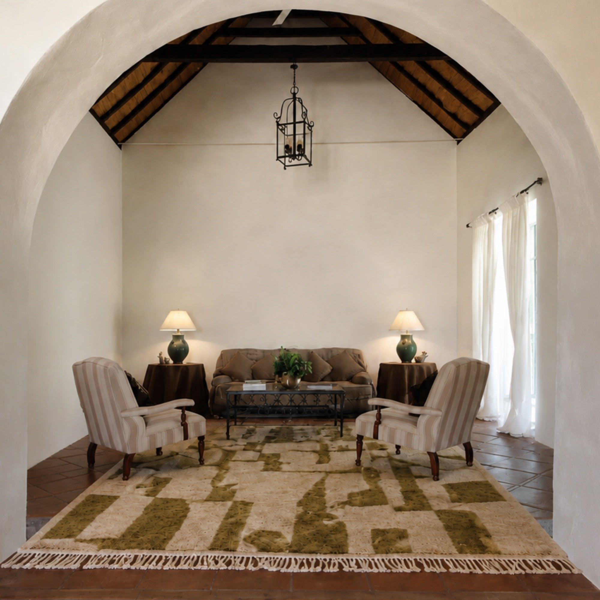Relic handmade Moroccan wool rug styled in an arched, Spanish-style living room with striped armchairs.