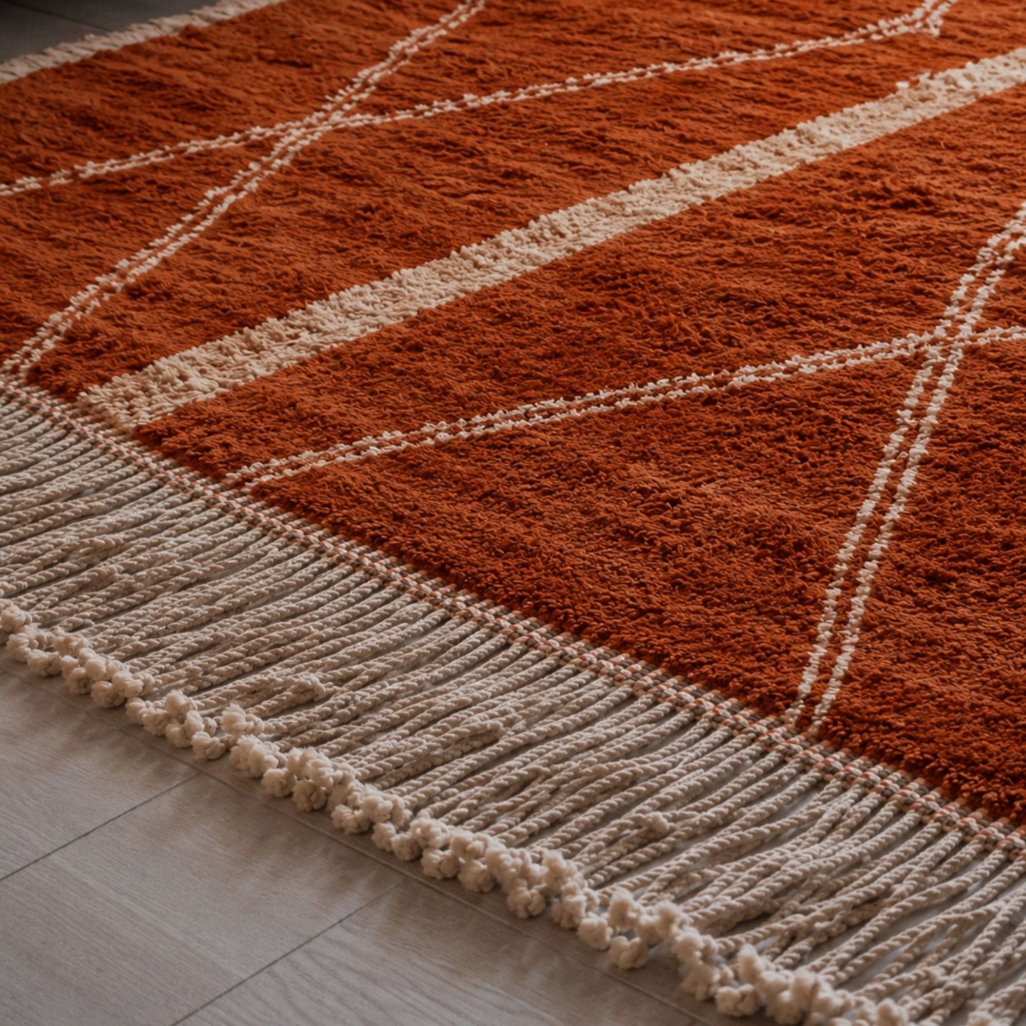 Sienna handmade Moroccan wool rug in burnt orange and ivory with hand-finished fringe detail