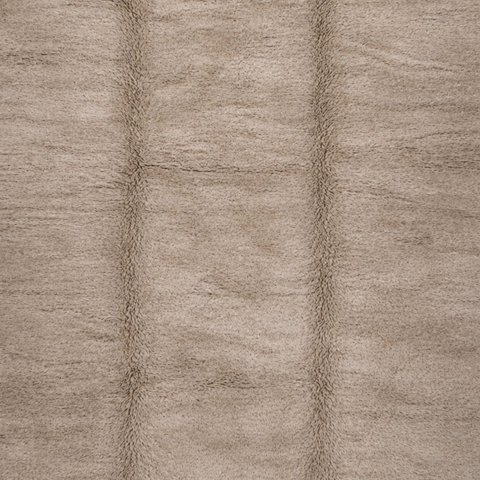 Soft high pile Moroccan rug texture in warm taupe, handcrafted wool fibers with subtle tonal variation