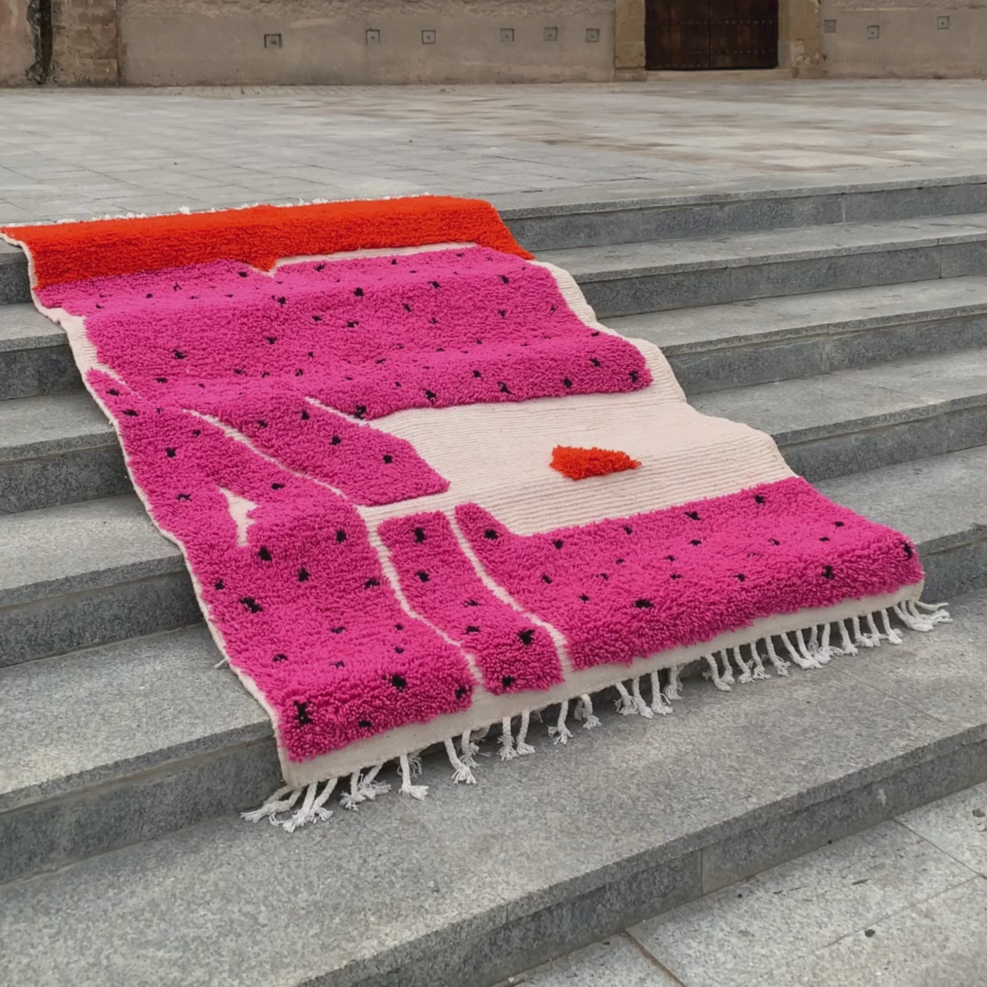 Melon Mirage pink Moroccan rug with black dotted design, handwoven by skilled Berber artisans