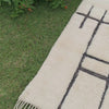 Mystic Muse white Moroccan rug with black geometric design, handwoven by Berber artisans.